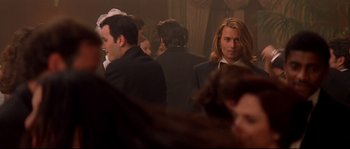 Movie still from “Blow” (2001), directed by Ted Demme – A group of people sitting in a room; Medium shot, Over the shoulder angle