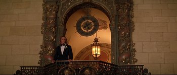 Movie still from “Blow” (2001), directed by Ted Demme – A man in a tuxedo standing in front of an ornate wall; Wide shot, Low angle