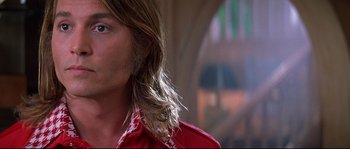 Movie still from “Blow” (2001), directed by Ted Demme – A person with long hair; Close Up shot, Low angle