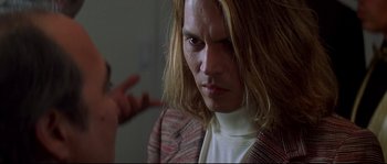 Movie still from “Blow” (2001), directed by Ted Demme – A person with long blonde hair; Close Up shot, Over the shoulder angle
