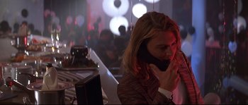 Movie still from “Blow” (2001), directed by Ted Demme – A man talking on a cell phone while sitting at a bar; Close Up shot, Low angle