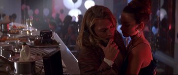 Movie still from “Blow” (2001), directed by Ted Demme – A man talking on a phone while holding another man's hand; Close Up shot, Low angle