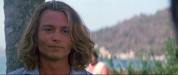 Movie still from “Blow” (2001), directed by Ted Demme – A person with long blonde hair; Close Up shot, Over the shoulder angle