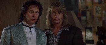 Movie still from “Blow” (2001), directed by Ted Demme – A couple of men standing next to each other; Close Up shot, Low angle