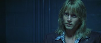 Movie still from “Blow” (2001), directed by Ted Demme – A man with long blonde hair wearing a black suit; Close Up shot, Low angle