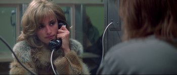 Movie still from “Blow” (2001), directed by Ted Demme – A woman is talking on a phone in front of a mirror; Close Up shot, Over the shoulder angle