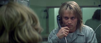 Movie still from “Blow” (2001), directed by Ted Demme – A man is talking on a phone in front of a mirror; Close Up shot, Over the shoulder angle