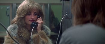 Movie still from “Blow” (2001), directed by Ted Demme – A woman is talking on a phone in front of a mirror; Close Up shot, High angle