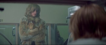 Movie still from “Blow” (2001), directed by Ted Demme – A woman is looking at herself in the mirror; Medium shot, Over the shoulder angle