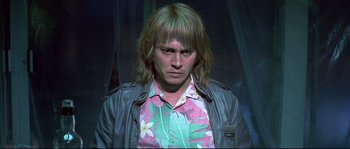 Movie still from “Blow” (2001), directed by Ted Demme – A man with long blonde hair wearing a floral shirt and jacket; Close Up shot, High angle