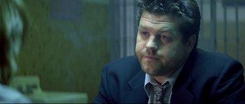 Movie still from “Blow” (2001), directed by Ted Demme – A person wearing a suit and tie; Close Up shot, Over the shoulder angle