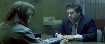 Movie still from “Blow” (2001), directed by Ted Demme – A man and a woman sitting at a table in front of each other; Medium shot, Over the shoulder angle