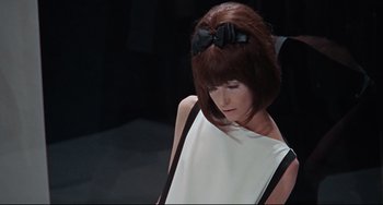 Movie still from “Blow-Up” (1966), directed by Michelangelo Antonioni – A woman with a black bow in her hair; Medium shot, Low angle