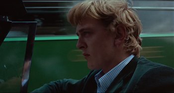 Movie still from “Blow-Up” (1966), directed by Michelangelo Antonioni – A person wearing a jacket; Close Up shot, Low angle