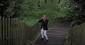Movie still from “Blow-Up” (1966), directed by Michelangelo Antonioni – A man taking a picture of himself on the steps; Wide shot, High angle