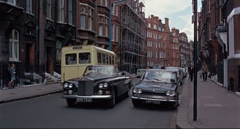Movie still from “Blow-Up” (1966), directed by Michelangelo Antonioni – Two cars parked on the side of the street; Extreme Wide shot, High angle