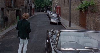 Movie still from “Blow-Up” (1966), directed by Michelangelo Antonioni – A row of cars parked on the side of the street; Wide shot, High angle