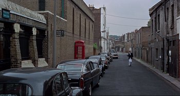 Movie still from “Blow-Up” (1966), directed by Michelangelo Antonioni – A row of cars parked on the side of the street; Extreme Wide shot, High angle