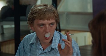 Movie still from “Blow-Up” (1966), directed by Michelangelo Antonioni – A man with a cigarette in his mouth; Close Up shot, Low angle