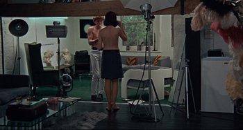 Movie still from “Blow-Up” (1966), directed by Michelangelo Antonioni – A man and a woman are taking a picture of each other in the mirror; Wide shot, High angle