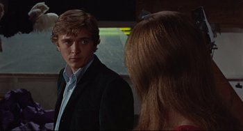 Movie still from “Blow-Up” (1966), directed by Michelangelo Antonioni – A man and a woman looking in the same direction in the mirror; Close Up shot, Over the shoulder angle