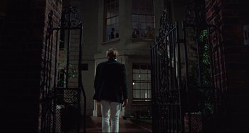 Movie still from “Blow-Up” (1966), directed by Michelangelo Antonioni – A woman standing in front of a building at night; Wide shot, Low angle