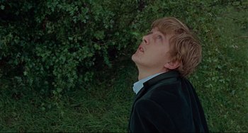 Movie still from “Blow-Up” (1966), directed by Michelangelo Antonioni – A young man looking up into the sky; Close Up shot, Low angle