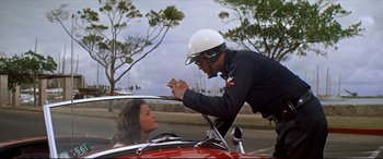 Movie still from “Blue Hawaii” (1961), directed by Norman Taurog – A man and a woman in a red car; Medium shot, Low angle