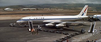Movie still from “Blue Hawaii” (1961), directed by Norman Taurog – An airplane is parked on the tarmac at an airport; Extreme Wide shot, High angle
