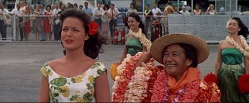 Movie still from “Blue Hawaii” (1961), directed by Norman Taurog – A group of women standing next to each other on the street; Medium shot, Low angle