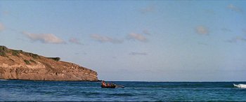 Movie still from “Blue Hawaii” (1961), directed by Norman Taurog – A group of people in a boat in the ocean; Extreme Wide shot, Low angle