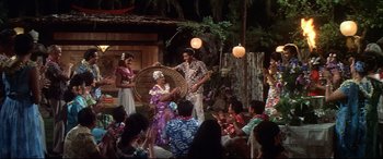 Movie still from “Blue Hawaii” (1961), directed by Norman Taurog – A group of people are performing a hawaiian dance; Wide shot, High angle