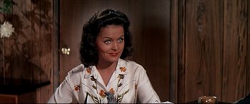 Movie still from “Blue Hawaii” (1961), directed by Norman Taurog – A woman in a white shirt with flowers on it; Close Up shot, Over the shoulder angle