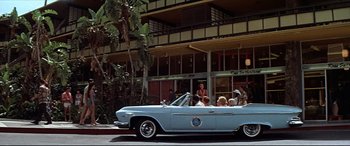 Movie still from “Blue Hawaii” (1961), directed by Norman Taurog – People in the back seat of a vintage car; Wide shot, Low angle