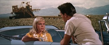 Movie still from “Blue Hawaii” (1961), directed by Norman Taurog – A man and a woman sitting in the back of a car; Medium shot, Over the shoulder angle