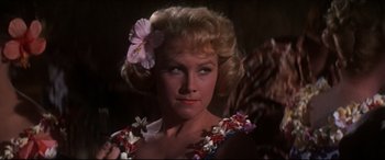 Movie still from “Blue Hawaii” (1961), directed by Norman Taurog – A blonde woman with a flower in her hair; Close Up shot, Low angle