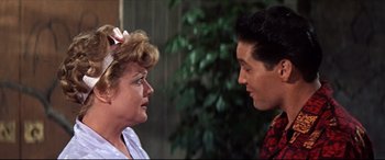 Movie still from “Blue Hawaii” (1961), directed by Norman Taurog – A woman and a young man talking to each other; Close Up shot, Over the shoulder angle