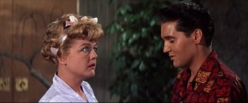 Movie still from “Blue Hawaii” (1961), directed by Norman Taurog – A couple of people that are talking to each other; Close Up shot, Over the shoulder angle
