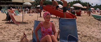 Movie still from “Blue Hawaii” (1961), directed by Norman Taurog – A woman in a bathing suit sitting on a beach chair; Medium shot, High angle