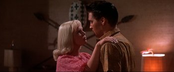 Movie still from “Blue Hawaii” (1961), directed by Norman Taurog – A man and a woman standing next to each other; Close Up shot, Low angle