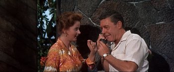 Movie still from “Blue Hawaii” (1961), directed by Norman Taurog – An older man and woman are talking on a phone; Medium shot, High angle