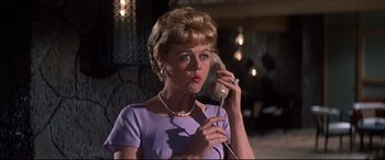 Movie still from “Blue Hawaii” (1961), directed by Norman Taurog – An older woman talking on a phone while wearing a purple dress; Close Up shot, Low angle