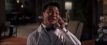 Movie still from “Blue Hawaii” (1961), directed by Norman Taurog – A man talking on a phone while wearing a bow tie; Close Up shot, Low angle