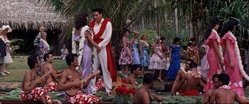 Movie still from “Blue Hawaii” (1961), directed by Norman Taurog – A group of people dressed in hawaiian clothing; Wide shot, Over the shoulder angle