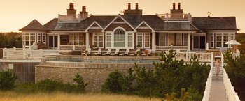 Movie still from “Blue Jasmine” (2013), directed by Woody Allen – A house that has a swimming pool in front of it; Extreme Wide shot, High angle