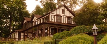 Movie still from “Blue Jasmine” (2013), directed by Woody Allen – A house that has been built in the woods; Extreme Wide shot, Low angle