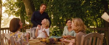 Movie still from “Blue Jasmine” (2013), directed by Woody Allen – A group of people sitting at a table with food; Medium shot, Over the shoulder angle