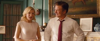 Movie still from “Blue Jasmine” (2013), directed by Woody Allen – A man and a woman standing next to each other in a room; Medium shot, Over the shoulder angle