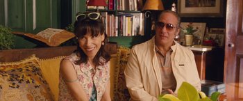 Movie still from “Blue Jasmine” (2013), directed by Woody Allen – A woman sitting next to a man wearing sunglasses; Medium shot, Over the shoulder angle