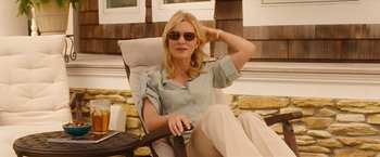 Movie still from “Blue Jasmine” (2013), directed by Woody Allen – A woman sitting in a chair with her hand up to her head; Medium shot, Low angle